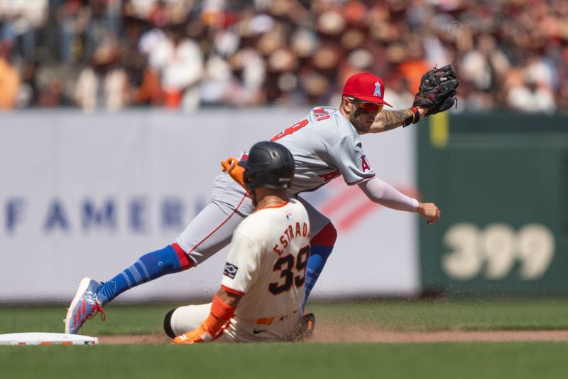 Jun 16, 2024; San Francisco, California, USA; Los Angeles Angels shortstop Zach Neto (9) tags out San Francisco Giants second base Thairo Estrada (39) during the seventh inning at Oracle Park. Mandatory Credit: Stan Szeto-USA TODAY Sports