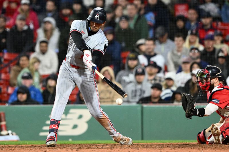 Sep 20, 2024; Boston, Massachusetts, USA; Minnesota Twins left fielder Trevor Larnach (9) hits a RBI single against the Boston Red Sox during the 12th  inning at Fenway Park. Mandatory Credit: Brian Fluharty-Imagn Images