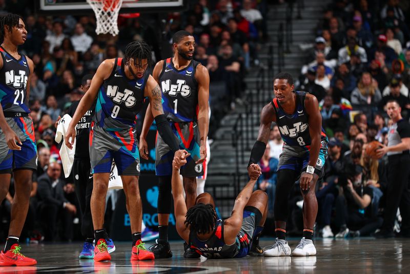 BROOKLYN, NY - APRIL 6: Trendon Watford #9, and Lonnie Walker IV #8 help up Cam Thomas #24 of the Brooklyn Nets during the game against the Detroit Pistons on April 6, 2024 at Barclays Center in Brooklyn, New York. NOTE TO USER: User expressly acknowledges and agrees that, by downloading and or using this Photograph, user is consenting to the terms and conditions of the Getty Images License Agreement. Mandatory Copyright Notice: Copyright 2024 NBAE (Photo by David L. Nemec/NBAE via Getty Images)