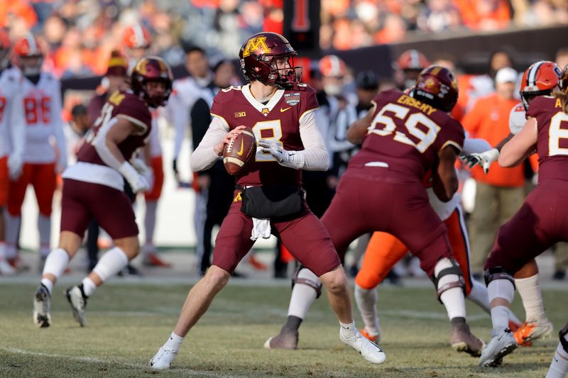 Dec 29, 2022; Bronx, NY, USA; Minnesota Golden Gophers quarterback Athan Kaliakmanis (8) drops back to pass against the Syracuse Orange during the first quarter of the 2022 Pinstripe Bowl at Yankee Stadium. Mandatory Credit: Brad Penner-USA TODAY Sports