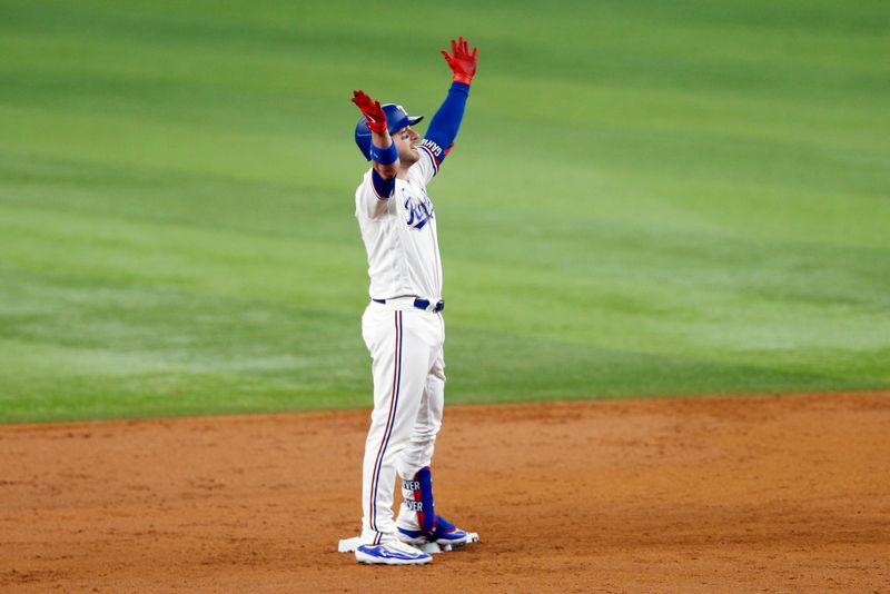 Oct 10, 2023; Arlington, Texas, USA; Texas Rangers catcher Mitch Garver (18) celebrates after hitting a two run double in the second inning against the Baltimore Orioles during game three of the ALDS for the 2023 MLB playoffs at Globe Life Field. Mandatory Credit: Andrew Dieb-USA TODAY Sports