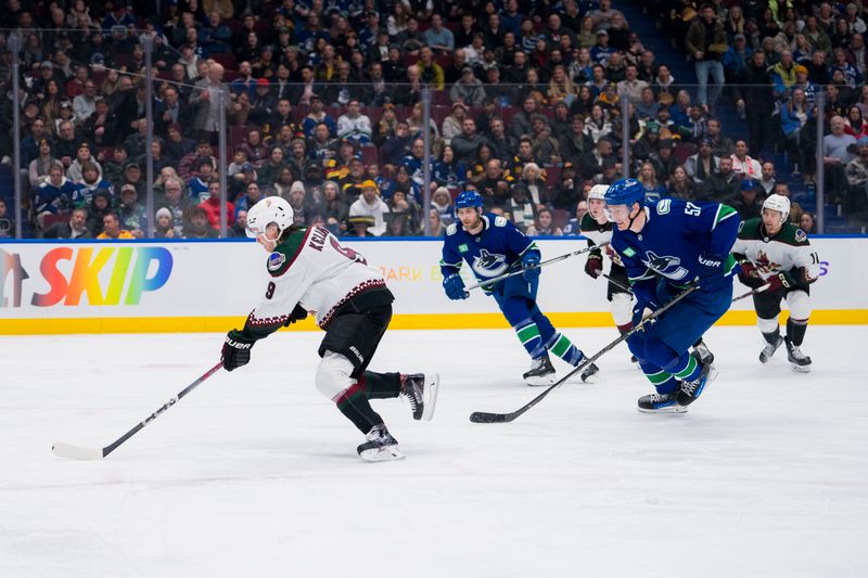 Jan 18, 2024; Vancouver, British Columbia, CAN; Vancouver Canucks defenseman Tyler Myers (57) pursues Arizona Coyotes forward Clayton Keller (9) on a breakaway in the second period at Rogers Arena. Mandatory Credit: Bob Frid-USA TODAY Sports