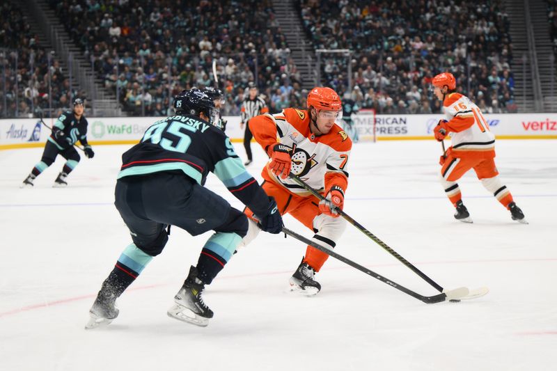 Nov 27, 2024; Seattle, Washington, USA; Anaheim Ducks right wing Frank Vatrano (77) plays the puck while defended by Seattle Kraken left wing Andre Burakovsky (95) during the first period at Climate Pledge Arena. Mandatory Credit: Steven Bisig-Imagn Images