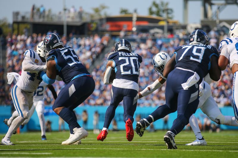 Tennessee Titans running back Tony Pollard (20) runs through a hole in the line during the second half of an NFL football game against the Indianapolis Colts, Sunday, Oct. 13, 2024, in Nashville, Tenn. (AP Photo/Stew Milne)