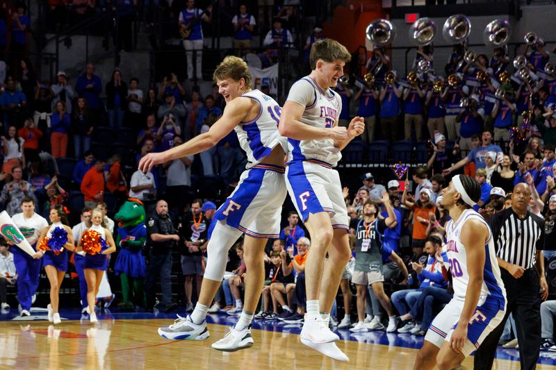 Jan 6, 2026; Gainesville, Florida, USA; Florida Gators forward Thomas Haugh (10) and forward Alex Condon (21) celebrate the win over the Georgia Bulldogs at Exactech Arena at the Stephen C. O'Connell Center. Mandatory Credit: Morgan Tencza-Imagn Images