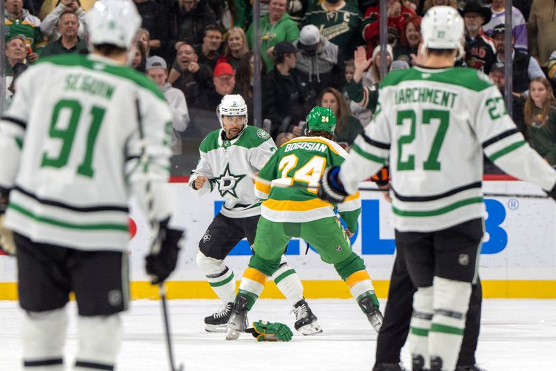 Nov 16, 2024; Saint Paul, Minnesota, USA; Dallas Stars defenseman Mathew Dumba (3) and Minnesota Wild defenseman Zach Bogosian (24) fight in the first period at Xcel Energy Center. Mandatory Credit: Matt Blewett-Imagn Images