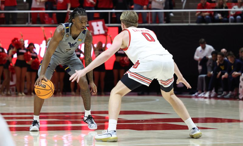 Mar 4, 2025; Salt Lake City, Utah, USA; West Virginia Mountaineers guard Javon Small (7) dribbles against Utah Utes guard Hunter Erickson (0) during the first half at Jon M. Huntsman Center. Mandatory Credit: Rob Gray-Imagn Images