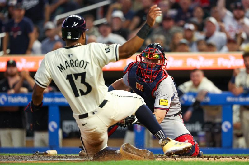 Aug 28, 2024; Minneapolis, Minnesota, USA; Atlanta Braves catcher Sean Murphy (12) tags out Minnesota Twins left fielder Manuel Margot (13) at home plate during the sixth inning at Target Field. Mandatory Credit: Matt Krohn-USA TODAY Sports