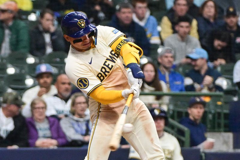 Apr 7, 2024; Milwaukee, Wisconsin, USA; Milwaukee Brewers catcher William Contreras (24) hits a single to drive in a run in the fourth inning against the Seattle Mariners at American Family Field. Mandatory Credit: Benny Sieu-USA TODAY Sports