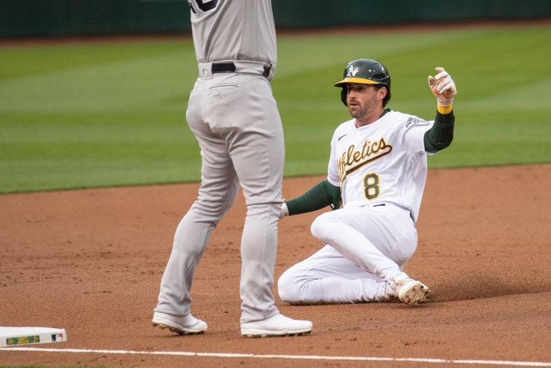 Jun 27, 2023; Oakland, California, USA; Oakland Athletics left fielder Tyler Wade (8) slides into third base after hitting a triple during the third inning against the New York Yankees at Oakland-Alameda County Coliseum. Mandatory Credit: Ed Szczepanski-USA TODAY Sports