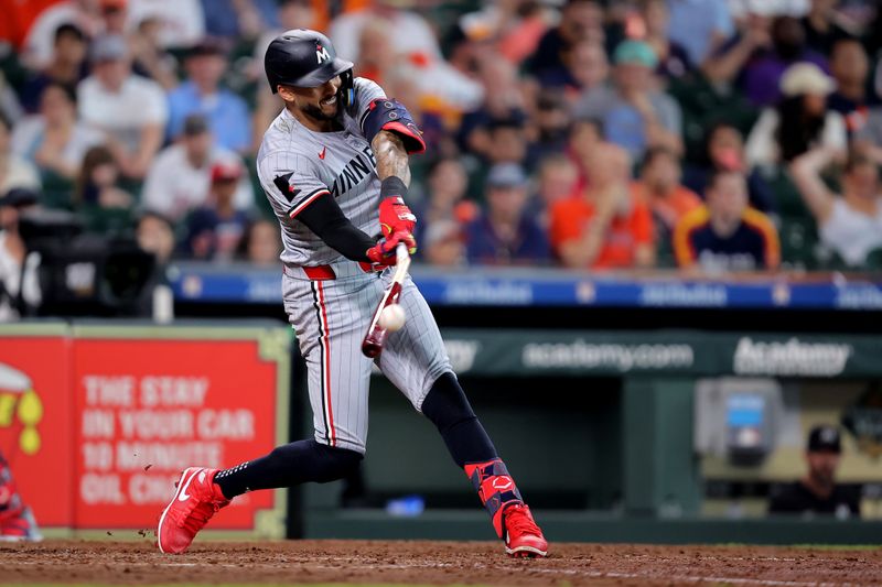 Jun 1, 2024; Houston, Texas, USA; Minnesota Twins shortstop Carlos Correa (4) hits an RBI single while breaking his bat against the Houston Astros during the eighth inning at Minute Maid Park. Mandatory Credit: Erik Williams-USA TODAY Sports