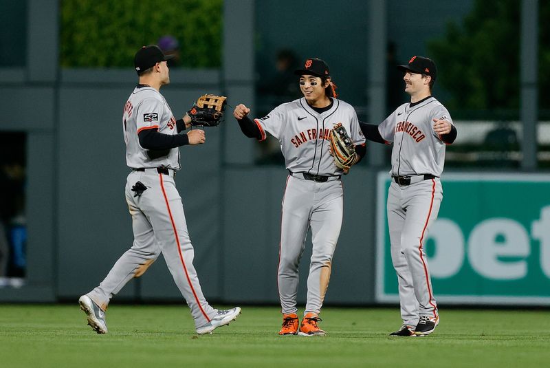 May 7, 2024; Denver, Colorado, USA; San Francisco Giants left fielder Michael Conforto (8) and center fielder Jung Hoo Lee (51) and right fielder Mike Yastrzemski (5) celebrate after the game against the Colorado Rockies at Coors Field. Mandatory Credit: Isaiah J. Downing-USA TODAY Sports