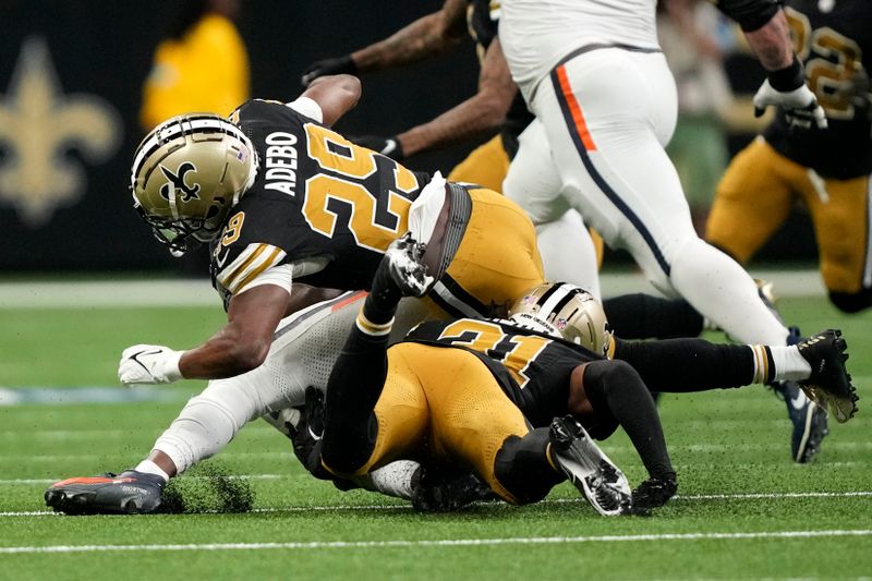 New Orleans Saints cornerback Paulson Adebo (29) is injured while making a tackle during the first half of an NFL football game against the Denver Broncos, Thursday, Oct. 17, 2024, in New Orleans. (AP Photo/Gerald Herbert)