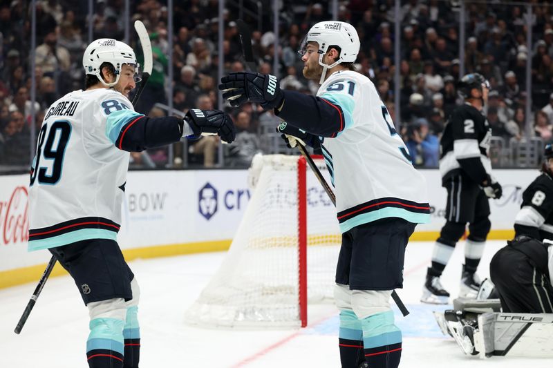 Feb 4, 2026; Los Angeles, California, USA;  Seattle Kraken center Shane Wright (51) celebrates with center Frederick Gaudreau (89) after scoring a goal during the third period against the Los Angeles Kings at Crypto.com Arena. Mandatory Credit: Kiyoshi Mio-Imagn Images