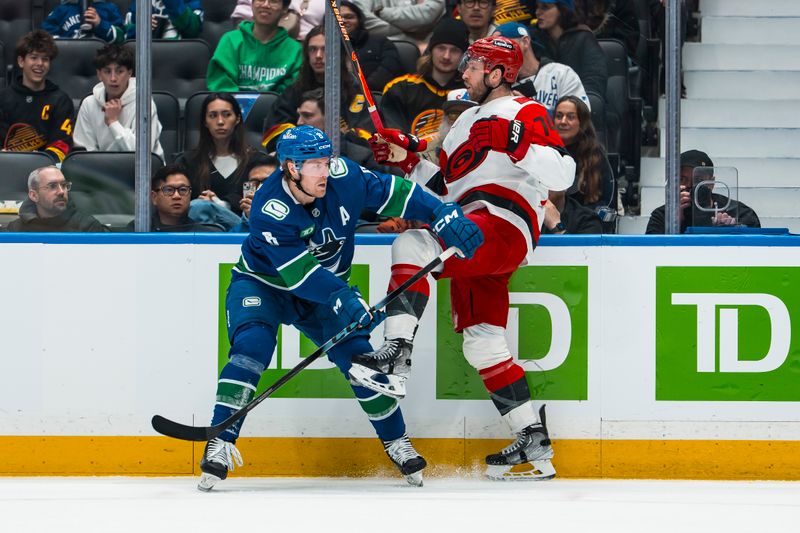 Mar 4, 2026; Vancouver, British Columbia, CAN; Vancouver Canucks forward Brock Boeser (6) checks Carolina Hurricanes defenseman Jaccob Slavin (74) in the first at Rogers Arena. Mandatory Credit: Bob Frid-Imagn Images