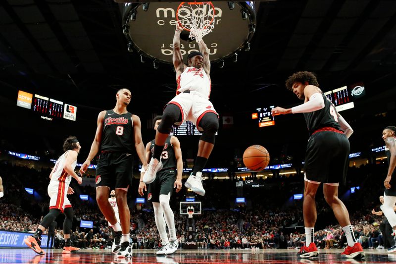 PORTLAND, OREGON - FEBRUARY 27: Jimmy Butler #22 of the Miami Heat dunks the ball as Kris Murray #8, Toumani Camara #33 , and Matisse Thybulle #4 of the Portland Trail Blazers look on during the second half at Moda Center on February 27, 2024 in Portland, Oregon. NOTE TO USER: User expressly acknowledges and agrees that, by downloading and or using this photograph, User is consenting to the terms and conditions of the Getty Images License Agreement. (Photo by Soobum Im/Getty Images)