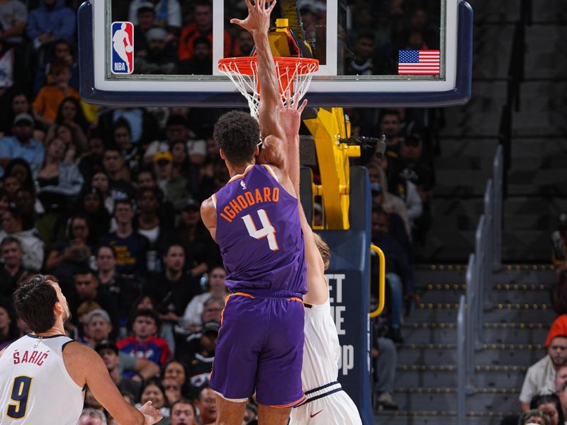 DENVER, CO - OCTOBER 13: Oso Ighodaro #4 of the Phoenix Suns drives to the basket during the game against the Denver Nuggets on October 13, 2024 at Ball Arena in Denver, Colorado. NOTE TO USER: User expressly acknowledges and agrees that, by downloading and/or using this Photograph, user is consenting to the terms and conditions of the Getty Images License Agreement. Mandatory Copyright Notice: Copyright 2024 NBAE (Photo by Garrett Ellwood/NBAE via Getty Images)