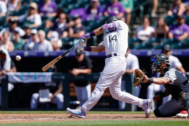 Aug 20, 2023; Denver, Colorado, USA; Colorado Rockies shortstop Ezequiel Tovar (14) hits an RBI single and would be called out attempting to stretch it into a double in the fifth inning against the Chicago White Sox at Coors Field. Mandatory Credit: Isaiah J. Downing-USA TODAY Sports