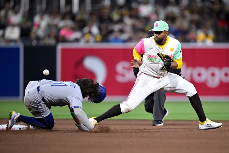 Apr 19, 2024; San Diego, California, USA; Toronto Blue Jays shortstop Bo Bichette (11) steals second base ahead of the throw to San Diego Padres second baseman Xander Bogaerts (2) during the seventh inning at Petco Park. Mandatory Credit: Orlando Ramirez-USA TODAY Sports 