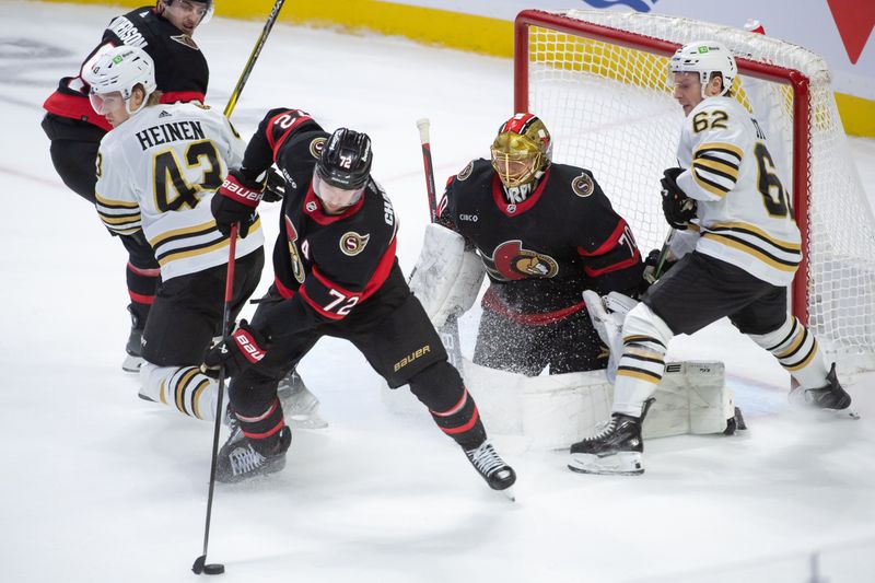 Jan 25, 2024; Ottawa, Ontario, CAN; Ottawa Senators defenseman Thomas Chabot (72) recovers the puck following a drive to the net by Boston Bruins center players Danton Heinen (43) and Oskar Steen (62) in the third period at the Canadian Tire Centre. Mandatory Credit: Marc DesRosiers-USA TODAY Sports