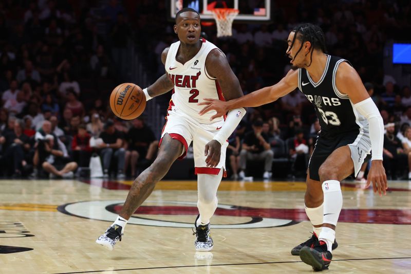 MIAMI, FLORIDA - OCTOBER 15: Terry Rozier #2 of the Miami Heat drives against Tre Jones #33 of the San Antonio Spurs during the second quarter of a preseason game at Kaseya Center on October 15, 2024 in Miami, Florida. NOTE TO USER: User expressly acknowledges and agrees that, by downloading and or using this photograph, User is consenting to the terms and conditions of the Getty Images License Agreement. (Photo by Megan Briggs/Getty Images)