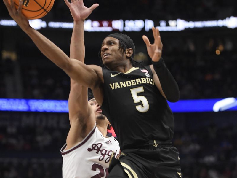 Mar 11, 2023; Nashville, TN, USA;  Vanderbilt Commodores guard Ezra Manjon (5) lays the ball in against the Texas A&M during the first half at Bridgestone Arena. Mandatory Credit: Steve Roberts-USA TODAY Sports