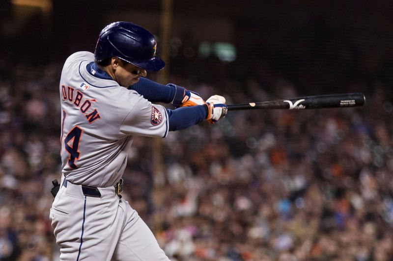 Jun 10, 2024; San Francisco, California, USA; Houston Astros left fielder Mauricio Dubón (14) grounds a single against the San Francisco Giants during the ninth inning at Oracle Park. Mandatory Credit: John Hefti-USA TODAY Sports