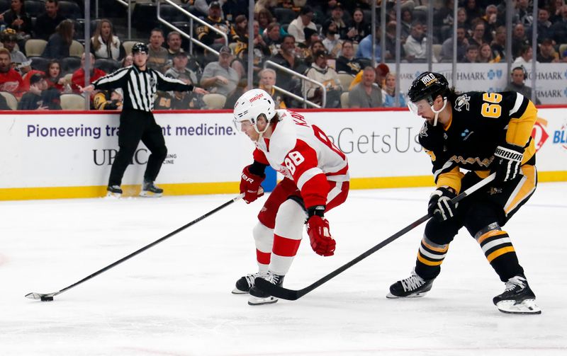 Apr 11, 2024; Pittsburgh, Pennsylvania, USA; Detroit Red Wings right wing Patrick Kane (88) skates with the puck as Pittsburgh Penguins defenseman Erik Karlsson (65) chases during the second period at PPG Paints Arena. Mandatory Credit: Charles LeClaire-USA TODAY Sports