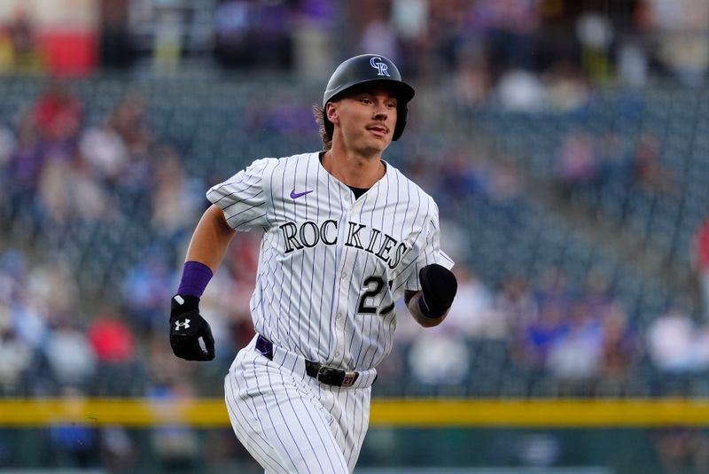 May 21, 2025; Denver, Colorado, USA; Colorado Rockies left fielder Jordan Beck (27) scores a run in the first inning against the Philadelphia Phillies at Coors Field. Mandatory Credit: Ron Chenoy-Imagn Images