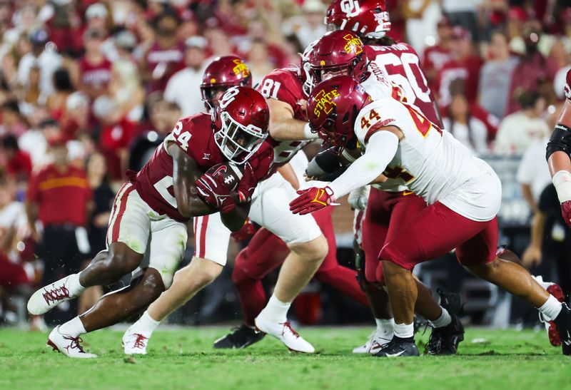 Sep 30, 2023; Norman, Oklahoma, USA;  Oklahoma Sooners running back Marcus Major (24) runs with the ball as Iowa State Cyclones linebacker Jacob Ellis (44) defends during the second half at Gaylord Family-Oklahoma Memorial Stadium. Mandatory Credit: Kevin Jairaj-USA TODAY Sports