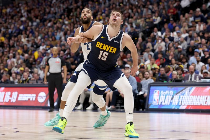 DENVER, COLORADO - APRIL 10: Nikola Jokic #15 of the Denver Nuggets boxes out Rudy Gobert #27 of the Minnesota Timberwolves during the third quarter at Ball Arena on April 10, 2024 in Denver, Colorado. NOTE TO USER: User expressly acknowledges and agrees that, by downloading and or using this photograph, User is consenting to the terms and conditions of the Getty Images License Agreement.  (Photo by Matthew Stockman/Getty Images)