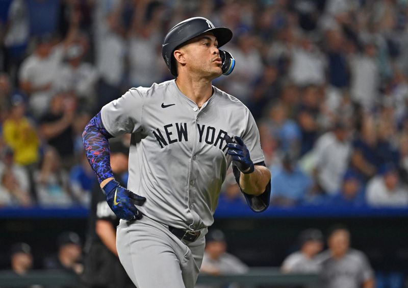 Jun 11, 2024; Kansas City, Missouri, USA; New York Yankees designated hitter Giancarlo Stanton (27) runs the bases after hitting a solo home run in the seventh inning against the Kansas City Royals at Kauffman Stadium. Mandatory Credit: Peter Aiken-USA TODAY Sports