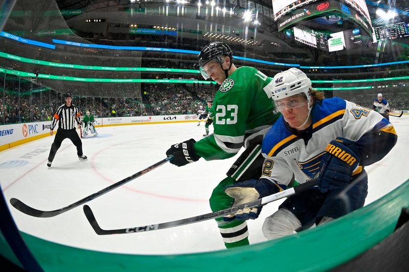 Apr 17, 2024; Dallas, Texas, USA; Dallas Stars defenseman Esa Lindell (23) and St. Louis Blues right wing Kasperi Kapanen (42) battle for control of the puck along the boards during the first period at the American Airlines Center. Mandatory Credit: Jerome Miron-USA TODAY Sports