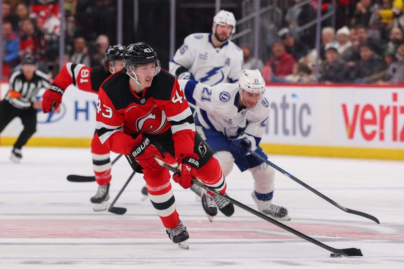 Dec 11, 2025; Newark, New Jersey, USA; New Jersey Devils defenseman Luke Hughes (43) skates with the puck against the Tampa Bay Lightning during the second period at Prudential Center. Mandatory Credit: Ed Mulholland-Imagn Images