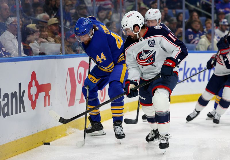 Oct 28, 2025; Buffalo, New York, USA;  Buffalo Sabres center Josh Dunne (44) and Columbus Blue Jackets defenseman Dante Fabbro (15) go after a loose puck behind the net during the second period at KeyBank Center. Mandatory Credit: Timothy T. Ludwig-Imagn Images
