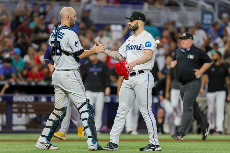 Sep 24, 2023; Miami, Florida, USA; Miami Marlins relief pitcher Tanner Scott (66) celebrates with catcher Jacob Stallings (58) after winning the game against the Milwaukee Brewers at loanDepot Park. Mandatory Credit: Sam Navarro-USA TODAY Sports