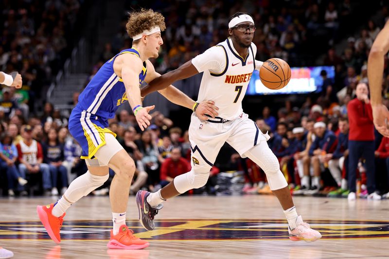 DENVER, COLORADO - DECEMBER 25: Reggie Jackson #7 of the Denver Nuggets drives against Brandin Podziemski #2 of the Golden State Warriors at Ball Arena on December 25, 2023 in Denver, Colorado. NOTE TO USER: User expressly acknowledges and agrees that, by downloading and/or using this Photograph, user is consenting to the terms and conditions of the Getty Images License Agreement. (Photo by Jamie Schwaberow/Getty Images)