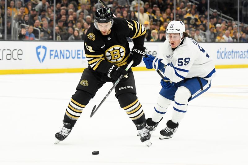 Apr 20, 2024; Boston, Massachusetts, USA; Boston Bruins defenseman Kevin Shattenkirk (12) controls the puck while Toronto Maple Leafs left wing Tyler Bertuzzi (59) defends during the first period in game one of the first round of the 2024 Stanley Cup Playoffs at TD Garden. Mandatory Credit: Bob DeChiara-USA TODAY Sports