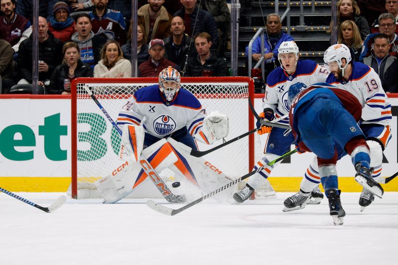 Jan 16, 2025; Denver, Colorado, USA; Colorado Avalanche center Parker Kelly (17) shoots against Edmonton Oilers goaltender Stuart Skinner (74) as defenseman Troy Stecher (51) and center Adam Henrique (19) defend in the first period at Ball Arena. Mandatory Credit: Isaiah J. Downing-Imagn Images