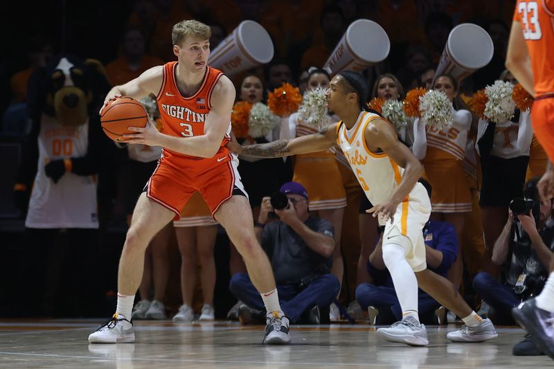 Dec 9, 2023; Knoxville, Tennessee, USA; Illinois Fighting Illini forward Marcus Domask (3) controls the ball against Tennessee Volunteers guard Zakai Zeigler (5) during the first half at Food City Center at Thompson-Boling Arena. Mandatory Credit: Randy Sartin-USA TODAY Sports