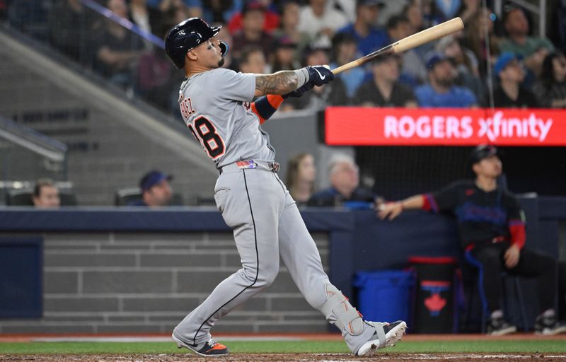 May 16, 2025; Toronto, Ontario, CAN;  Detroit Tigers center fielder Javier Baez (28) hits a solo home run against the Toronto Blue Jays in the eighth inning at Rogers Centre. Mandatory Credit: Dan Hamilton-Imagn Images