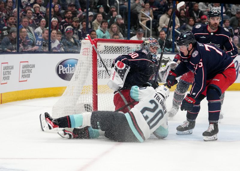 Mar 3, 2023; Columbus, Ohio, USA; Seattle Kraken right wing Eeli Tolvanen (20) crashes into Columbus Blue Jackets goaltender Elvis Merzlikins (90) during the first period at Nationwide Arena. Mandatory Credit: Jason Mowry-USA TODAY Sports