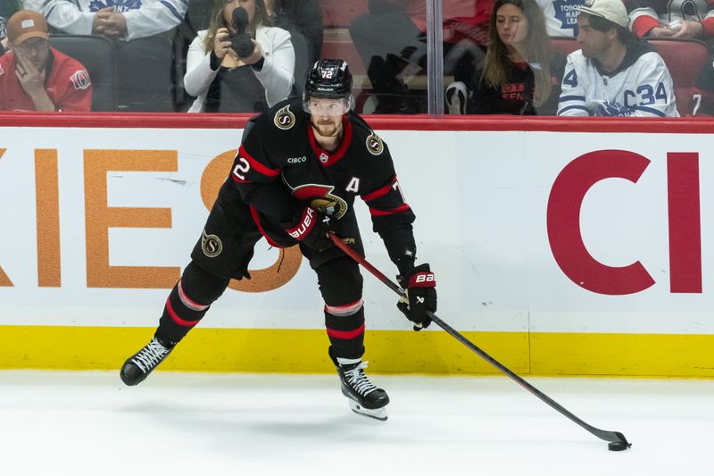 Apr 26, 2025; Ottawa, Ontario, CAN; Ottawa Senators defenseman Thomas Chabot (72) controls the puck in game four of the first round of the 2025 Stanley Cup Playoffs against the Toronto Maple Leafs in their game at the Canadian Tire Centre. Mandatory Credit: Marc DesRosiers-Imagn Images