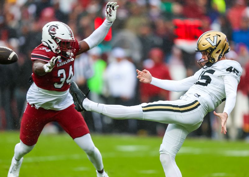 Nov 11, 2023; Columbia, South Carolina, USA; Vanderbilt Commodores punter Matthew Hayball (45) punts against South Carolina Gamecocks linebacker Jamian Risher Jr. (34) in the first quarter at Williams-Brice Stadium. Mandatory Credit: Jeff Blake-USA TODAY Sports