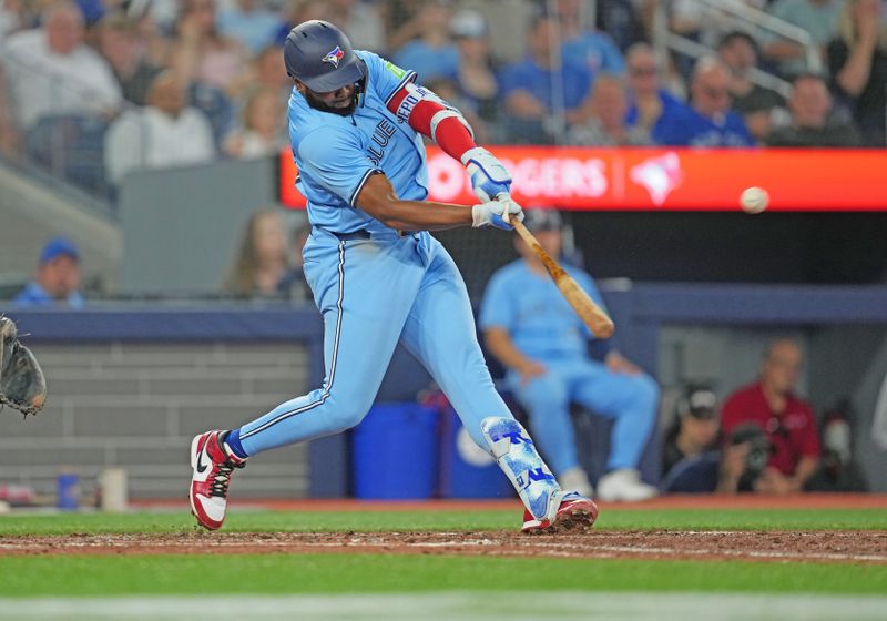 Jul 23, 2024; Toronto, Ontario, CAN; Toronto Blue Jays first base Vladimir Guerrero Jr. (27) hits a home run against the Tampa Bay Rays during the sixth inning at Rogers Centre. Mandatory Credit: Nick Turchiaro-USA TODAY Sports