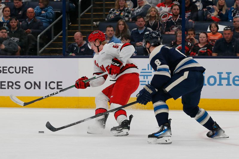 Apr 16, 2024; Columbus, Ohio, USA; Carolina Hurricanes right wing Jackson Blake (53) carries the puck as Columbus Blue Jackets defenseman Zach Werenski (8) defends during the first period at Nationwide Arena. Mandatory Credit: Russell LaBounty-USA TODAY Sports