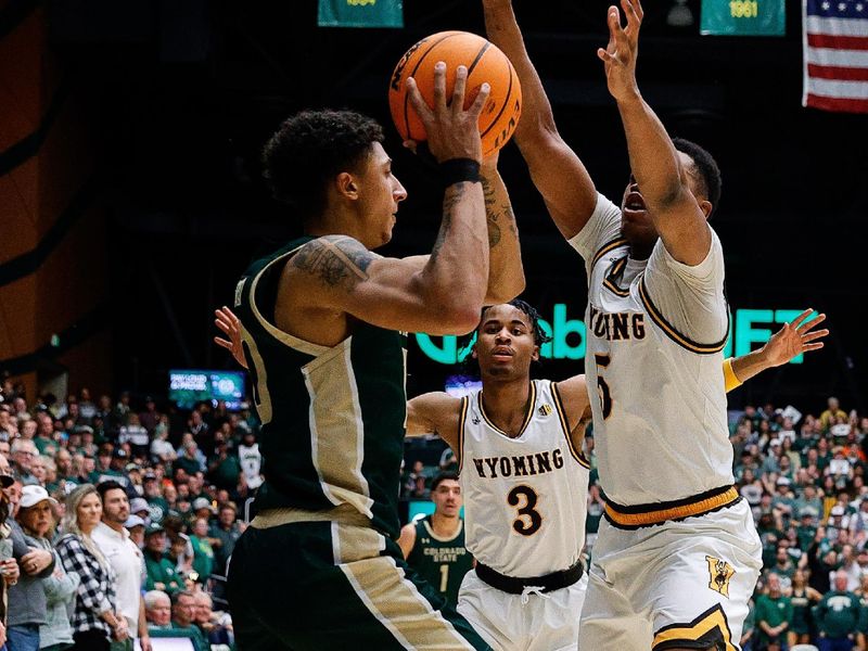 Mar 2, 2024; Fort Collins, Colorado, USA; Colorado State Rams guard Nique Clifford (10) controls the ball under pressure from Wyoming Cowboys forward Cam Manyawu (5) and guard Sam Griffin (3) in the second half at Moby Arena. Mandatory Credit: Isaiah J. Downing-USA TODAY Sports