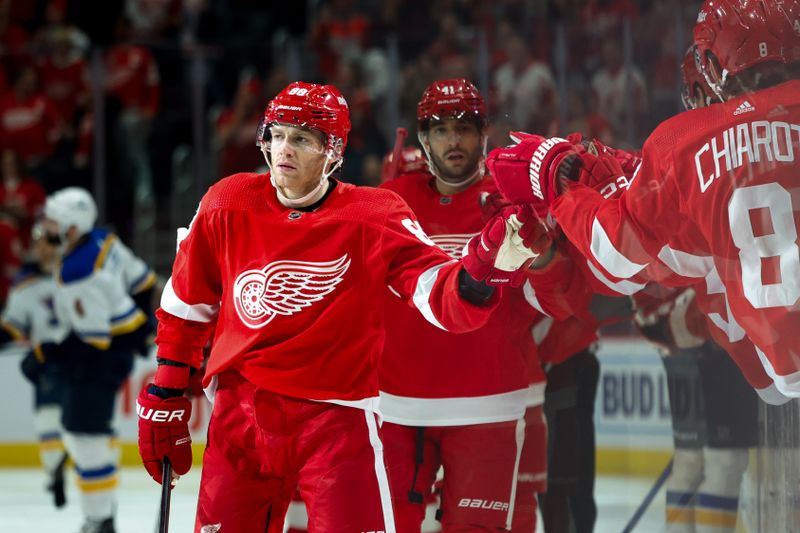 Feb 24, 2024; Detroit, Michigan, USA;  Detroit Red Wings right wing Patrick Kane (88) receives congratulations from teammates after scoring in the first period against the St. Louis Blues at Little Caesars Arena. Mandatory Credit: Rick Osentoski-USA TODAY Sports