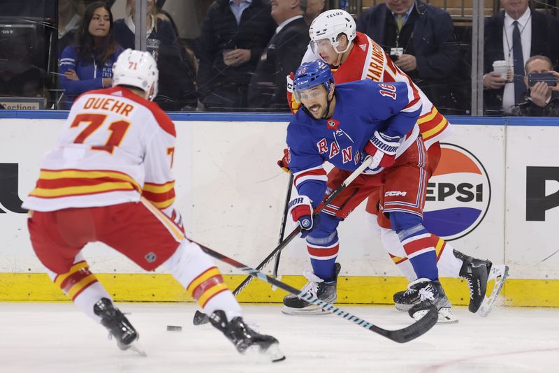 Feb 12, 2024; New York, New York, USA; New York Rangers center Vincent Trocheck (16) fights for the puck against Calgary Flames right wing Walker Duehr (71) and center Yegor Sharangovich (17) during the second period at Madison Square Garden. Mandatory Credit: Brad Penner-USA TODAY Sports