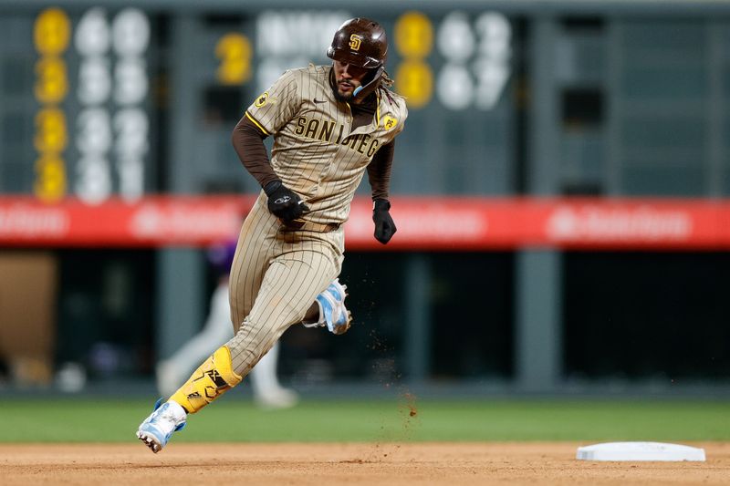 Apr 22, 2024; Denver, Colorado, USA; San Diego Padres right fielder Fernando Tatis Jr. (23) rounds second on a triple in the seventh inning against the Colorado Rockies at Coors Field. Mandatory Credit: Isaiah J. Downing-USA TODAY Sports